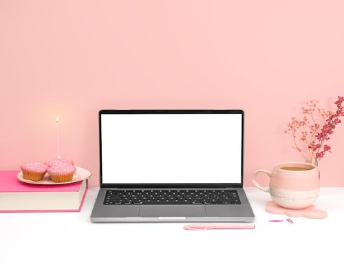aesthetic home office setup with cozy pink light and laptop