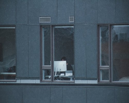 person taking a break from computer looking out the window
